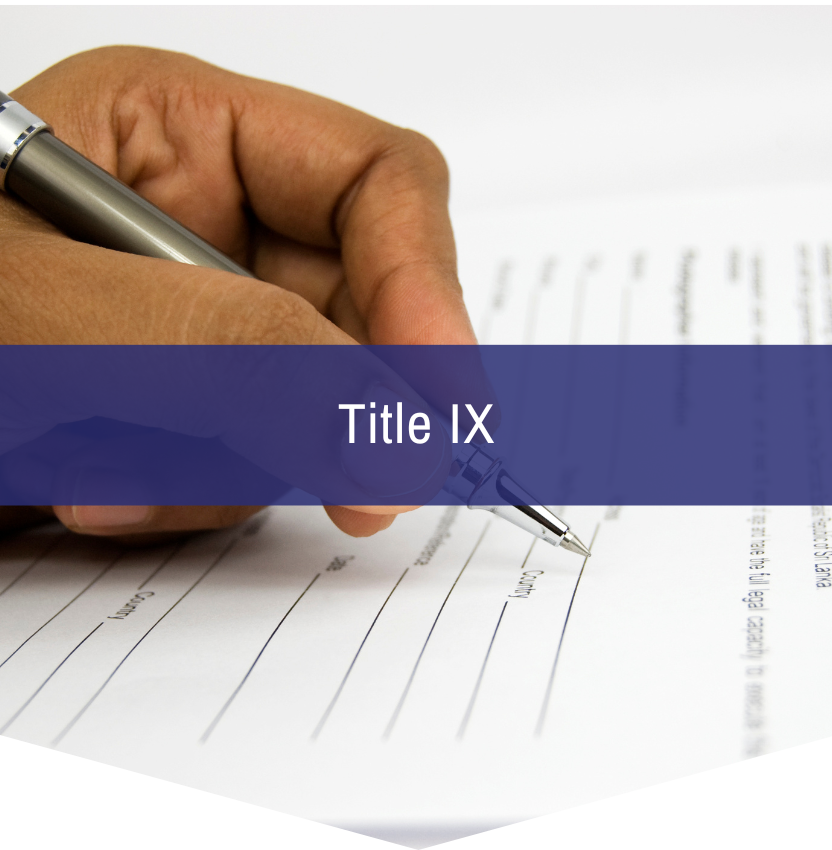 A person is writing on a piece of paper that says title ix