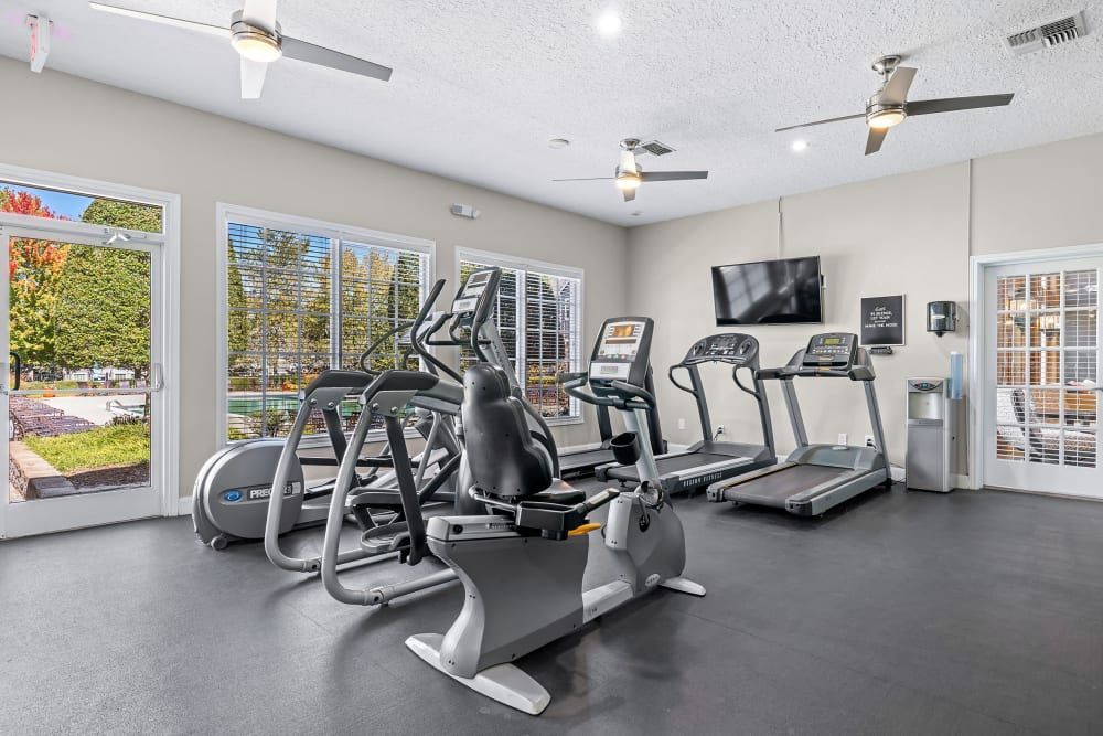 A fitness center with a lot of treadmills and exercise bikes at Marquis at Silverton in Cary, NC.