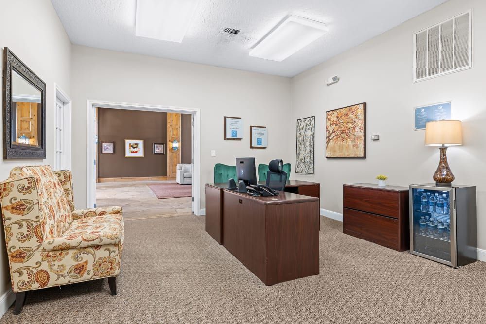 Leasing office with a desk, chair, lamp and mirror at Marquis at Silverton in Cary, NC.