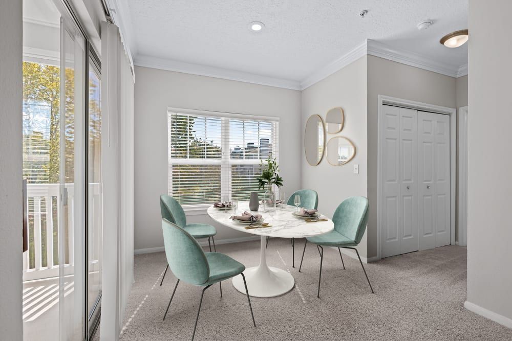 Apartment dining room with a table and chairs in front of a window at Marquis at Silverton in Cary, NC.