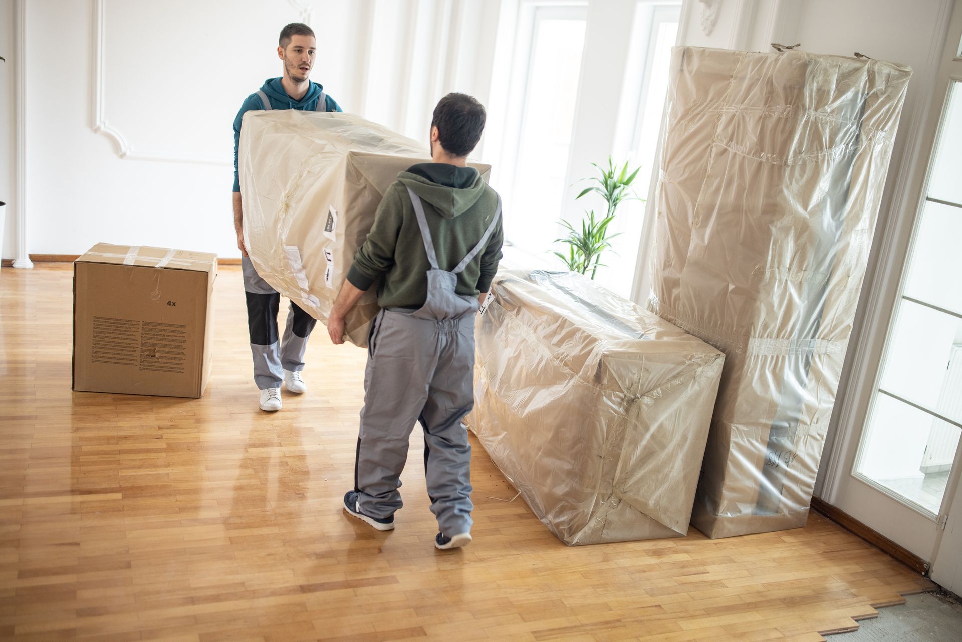 Professional movers carrying furniture in client's house| Redondo Van & Storage | Manhattan Beach, C