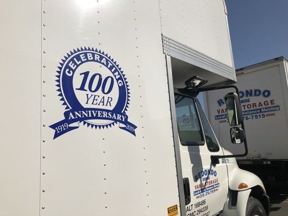 Moving truck with a 100-year anniversary logo on the side panel. Moving truck with a 100-year anniversary logo on the side panel.