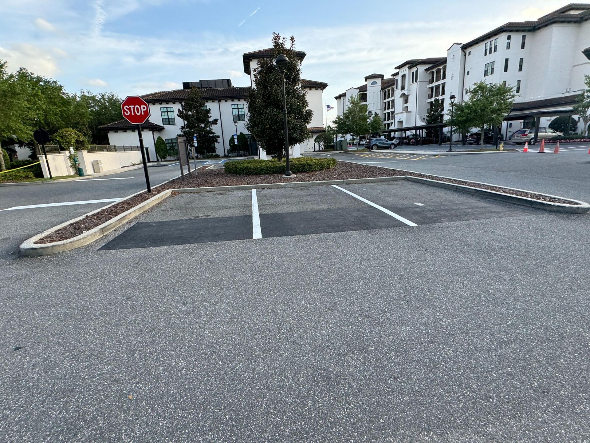 A parking lot with yellow lines and white curbs
