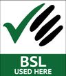 A green and white sign that says bsl used here