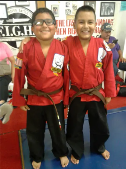 Two Boys Wearing Their Red Tae kwon Do Suit — Amarillo, TX — Amarillo Karate & Fitness