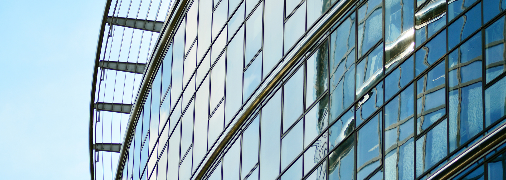 Picture of a curved glass building facade. 