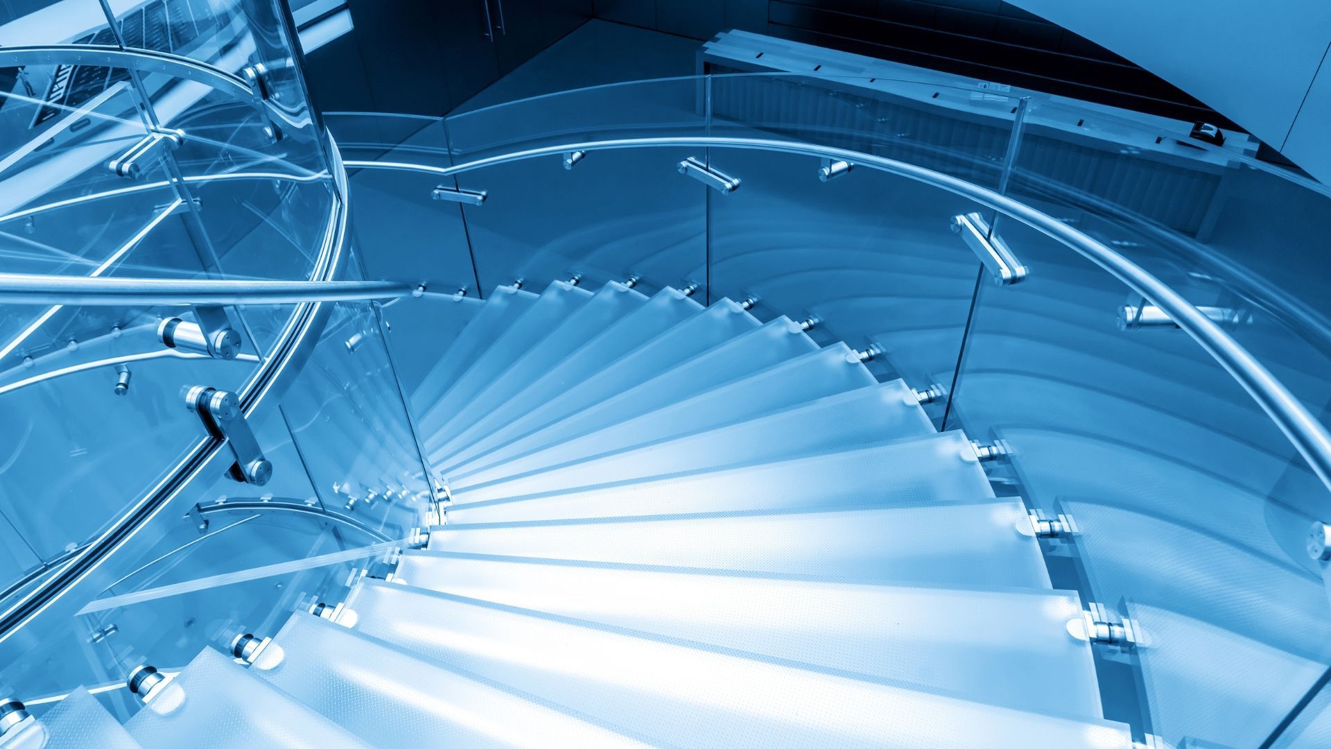 Explore key considerations and regulations when sourcing and installing curved glass for staircases.