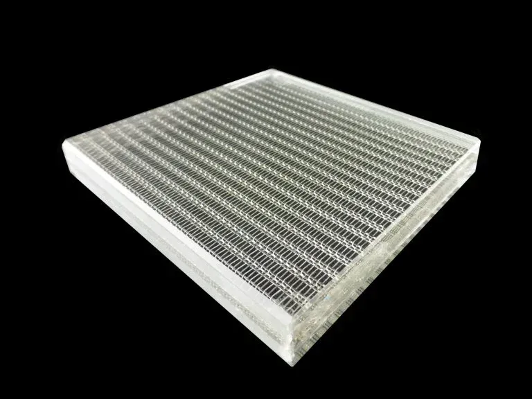 A piece of clear plastic with a grid pattern on a black background.