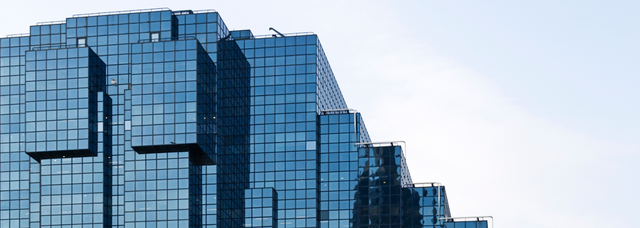 Picture of a large glass building. Picture of a large glass building.