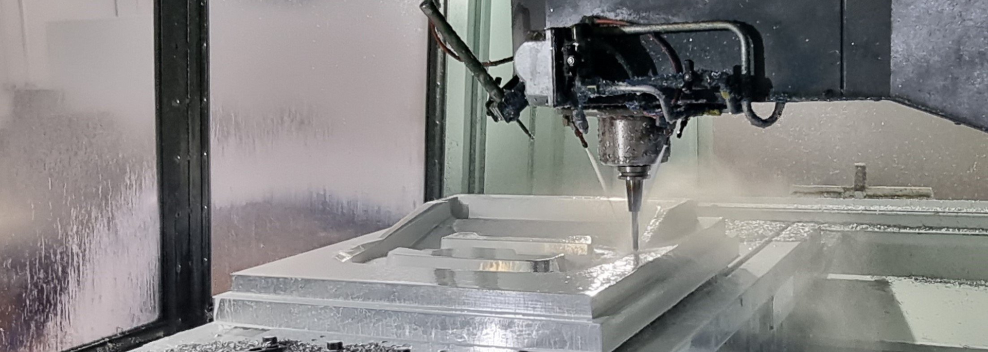 Picture of a piece of glass in a CNC machine