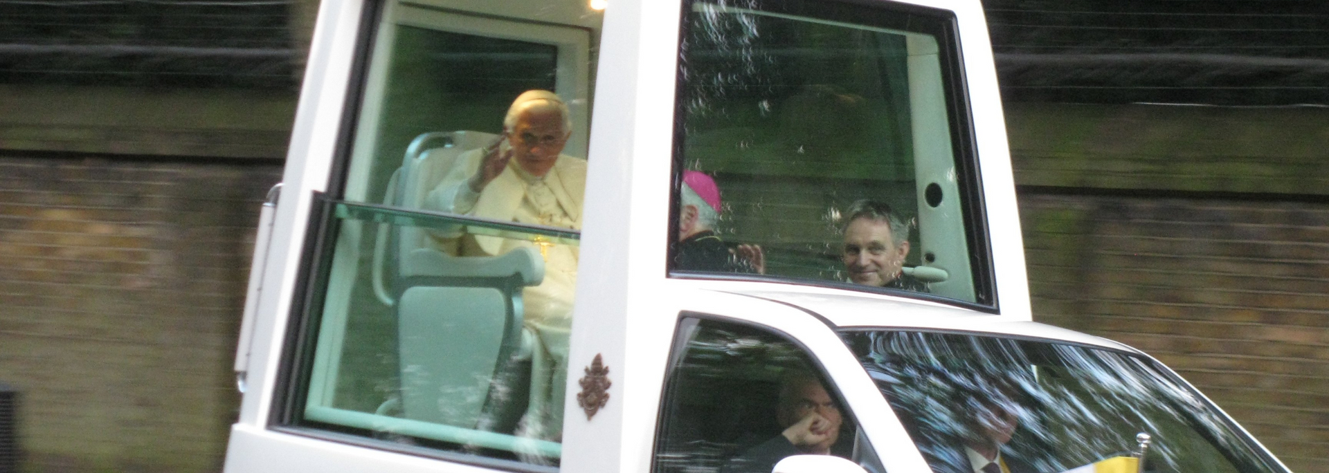 Picture of a popemobile with glass sides.