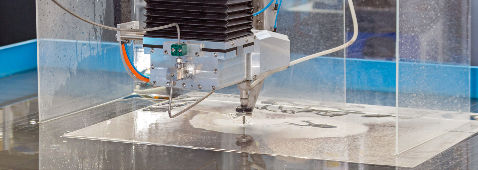 Picture of a water jet cutter in action.