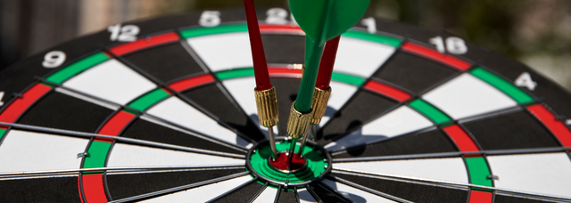 Picture of darts hitting a bullseye. Picture of darts hitting a bullseye.