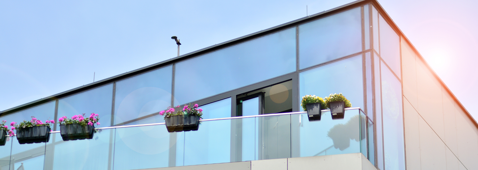 Picture of a modern building with a glass balcony. Picture of a modern building with a glass balcony.