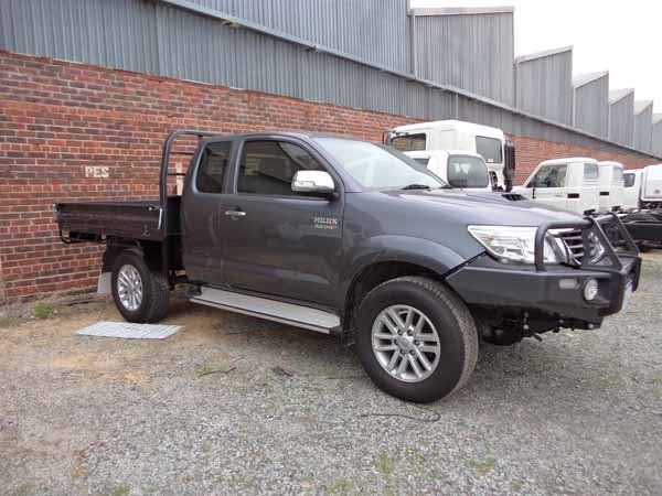 A Toyota Hilux Pickup Truck Is Parked in Front of A Brick Building — Welshpool, WA — PTE Group Pty Ltd