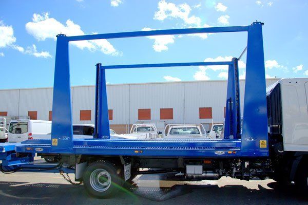 A Blue Flatbed Truck Is Parked in Front of A Building — Welshpool, WA — PTE Group Pty Ltd