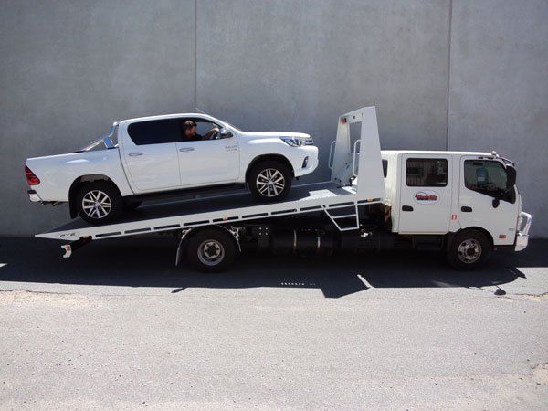 A White Truck Is Sitting on Top of A Beautiful White Tow Truck — Welshpool, WA — PTE Group Pty Ltd