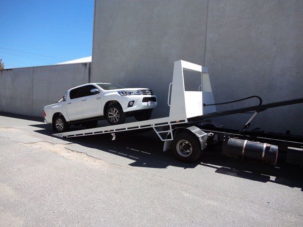 A White Truck Is Being Towed by A Tow Truck — Welshpool, WA — PTE Group Pty Ltd