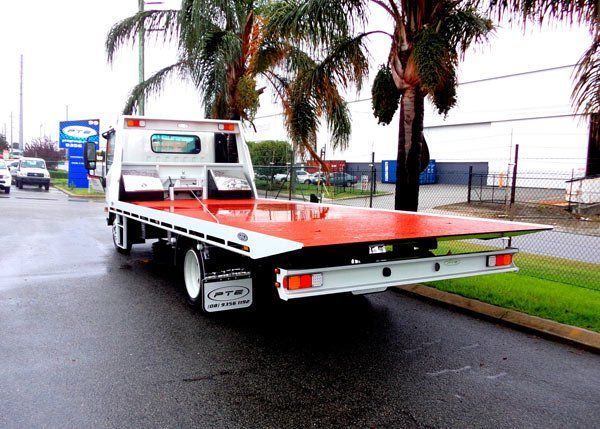 A Tow Truck Is Parked on The Side of The Road Next to A Palm Tree — Welshpool, WA — PTE Group Pty Ltd