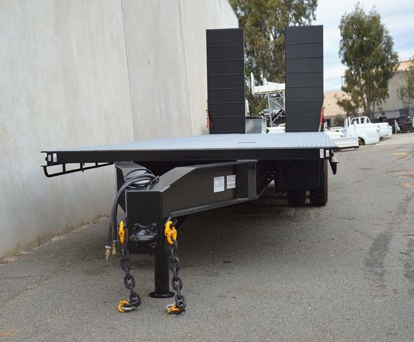 A Flatbed Trailer Is Parked in A Parking Lot Next to A Building — Welshpool, WA — PTE Group Pty Ltd