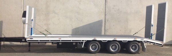 A Flatbed Trailer Is Parked in Front of A Concrete Wall — Welshpool, WA — PTE Group Pty Ltd
