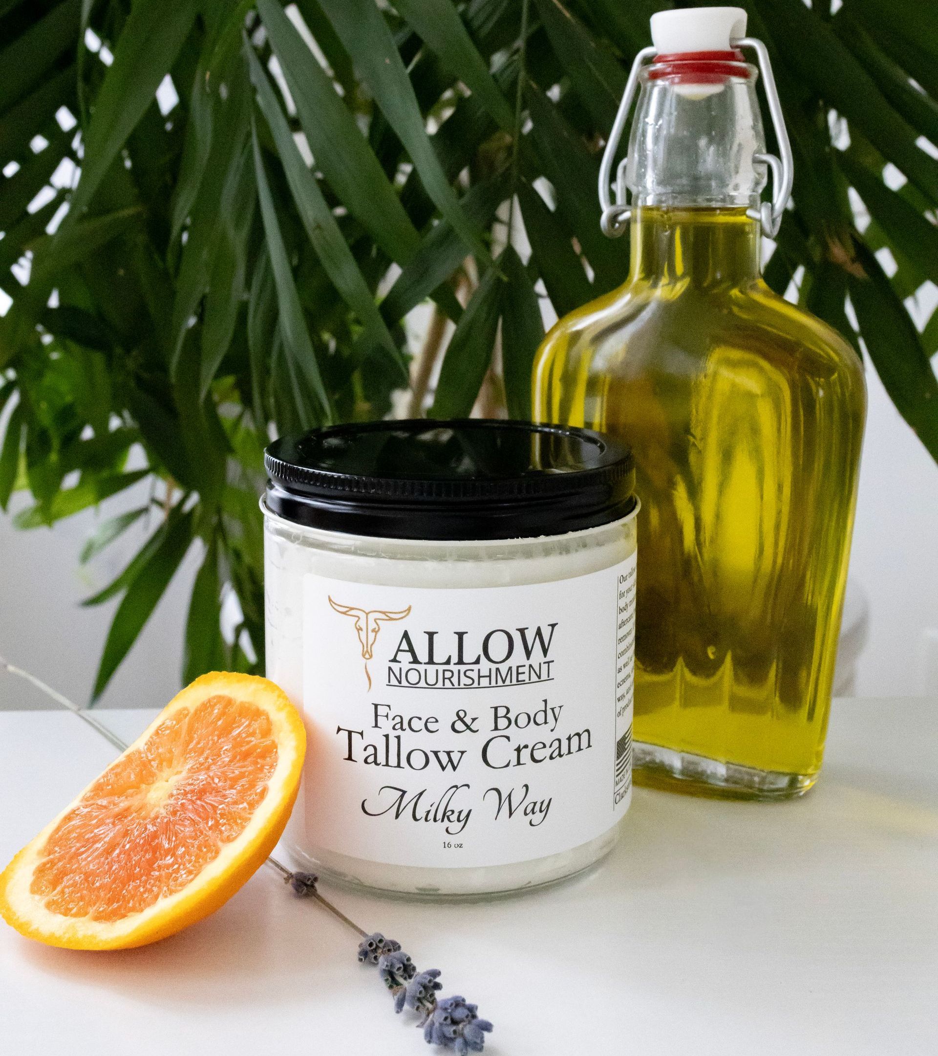 A jar of Allow Nourishment Milky Way Face & Body Cream next to an orange