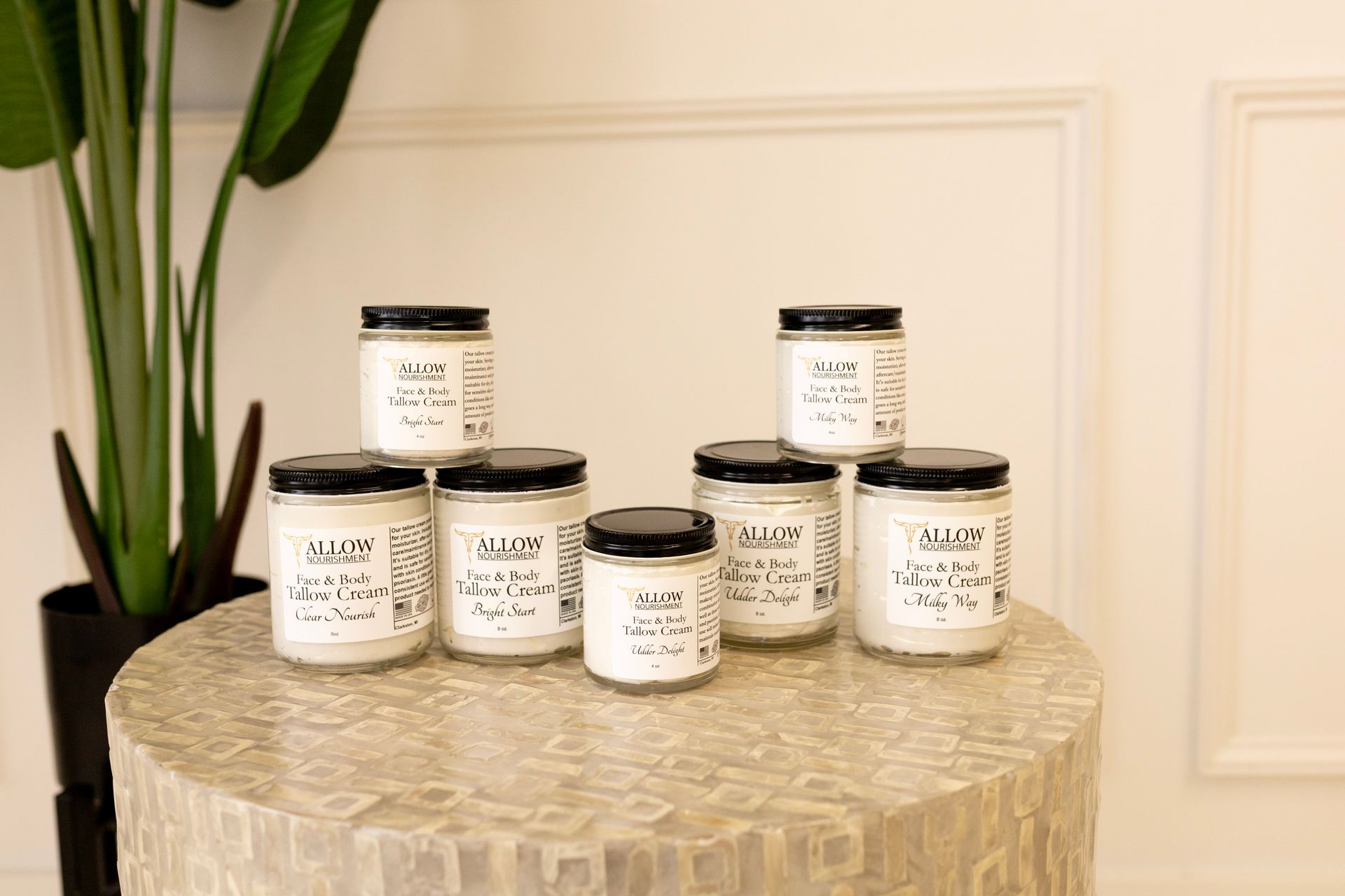 several jars of allow nourishment's skincare products are on a table