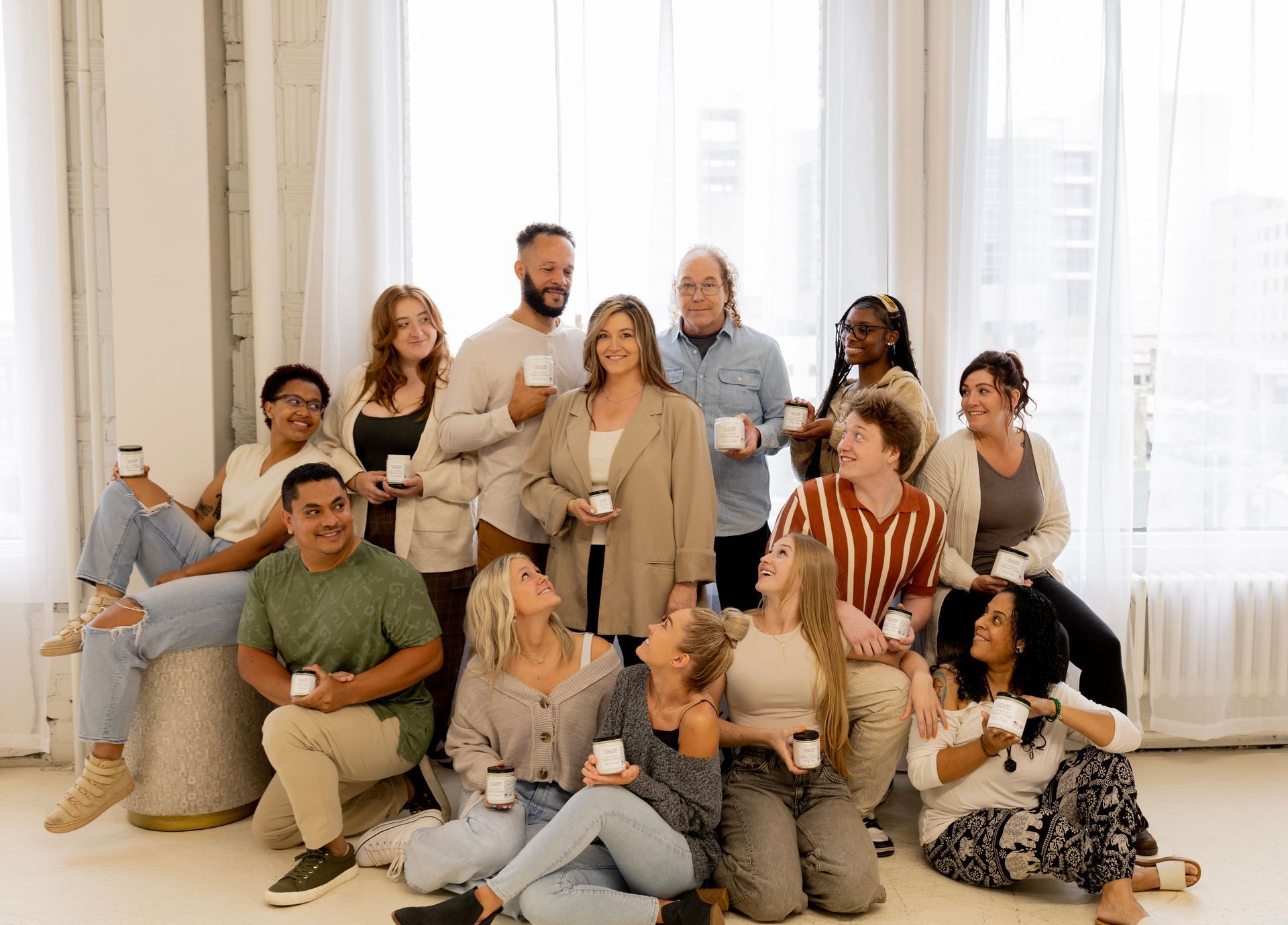 A group of people with Allow Nourishment holding beef tallow products. 