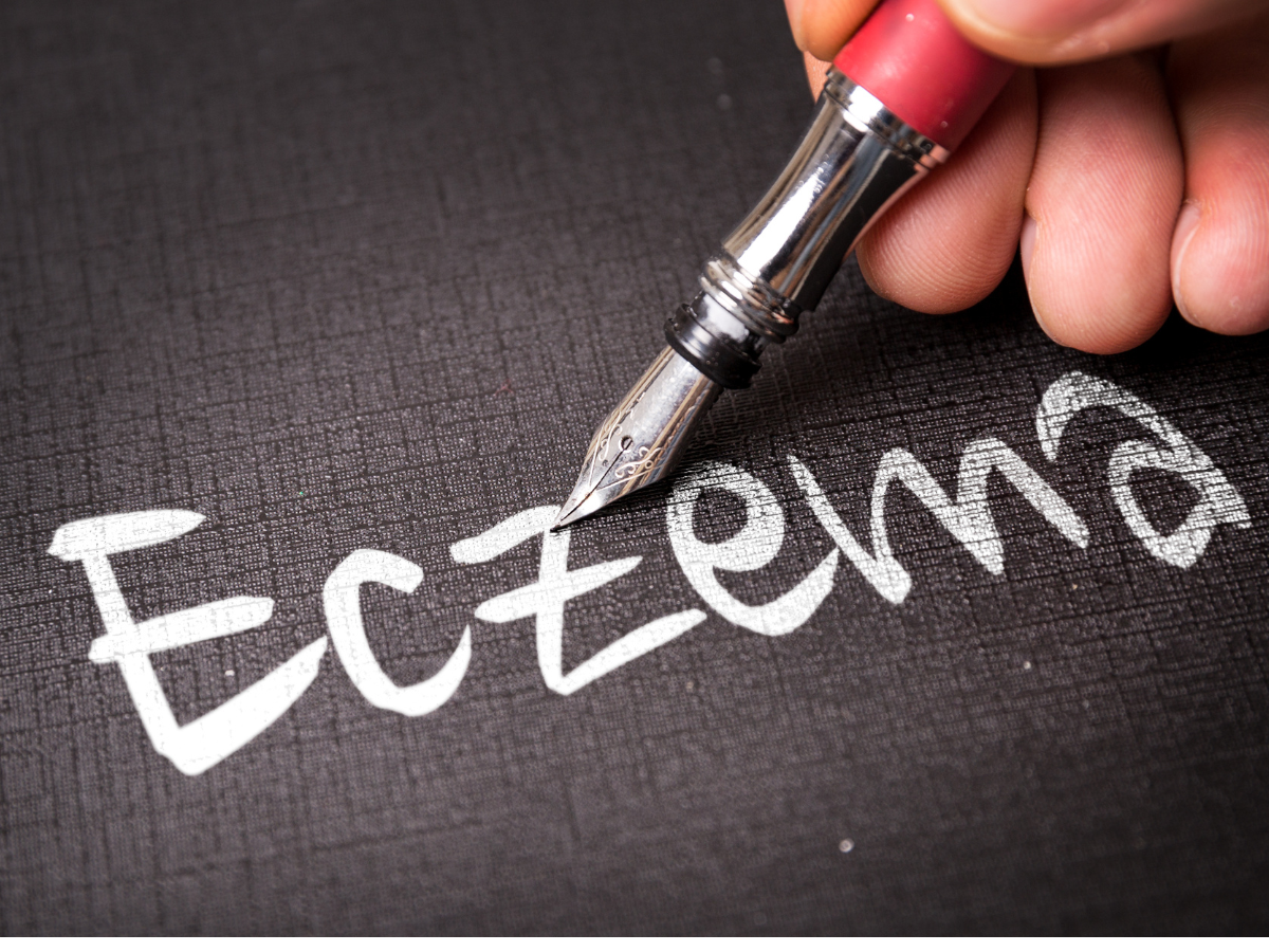 someone is writing the word eczema with a fountain pen