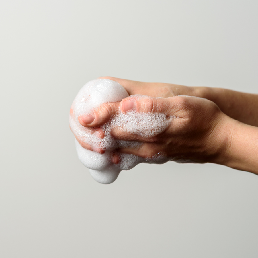 Allow Nourishment / A person is holding a bubble of tallow soap in their hands.