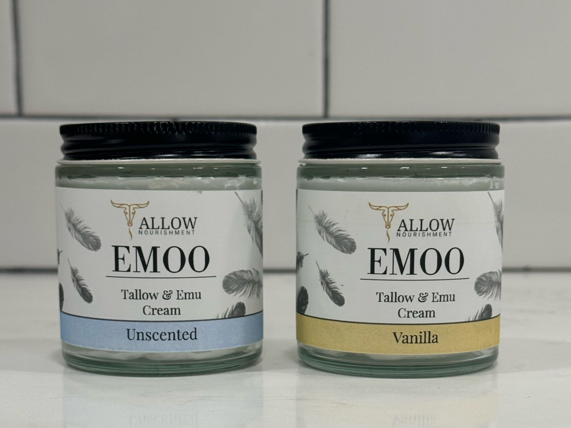 two jars of Allow Nourishments emoo tallow Face & Body cream sitting on a counter