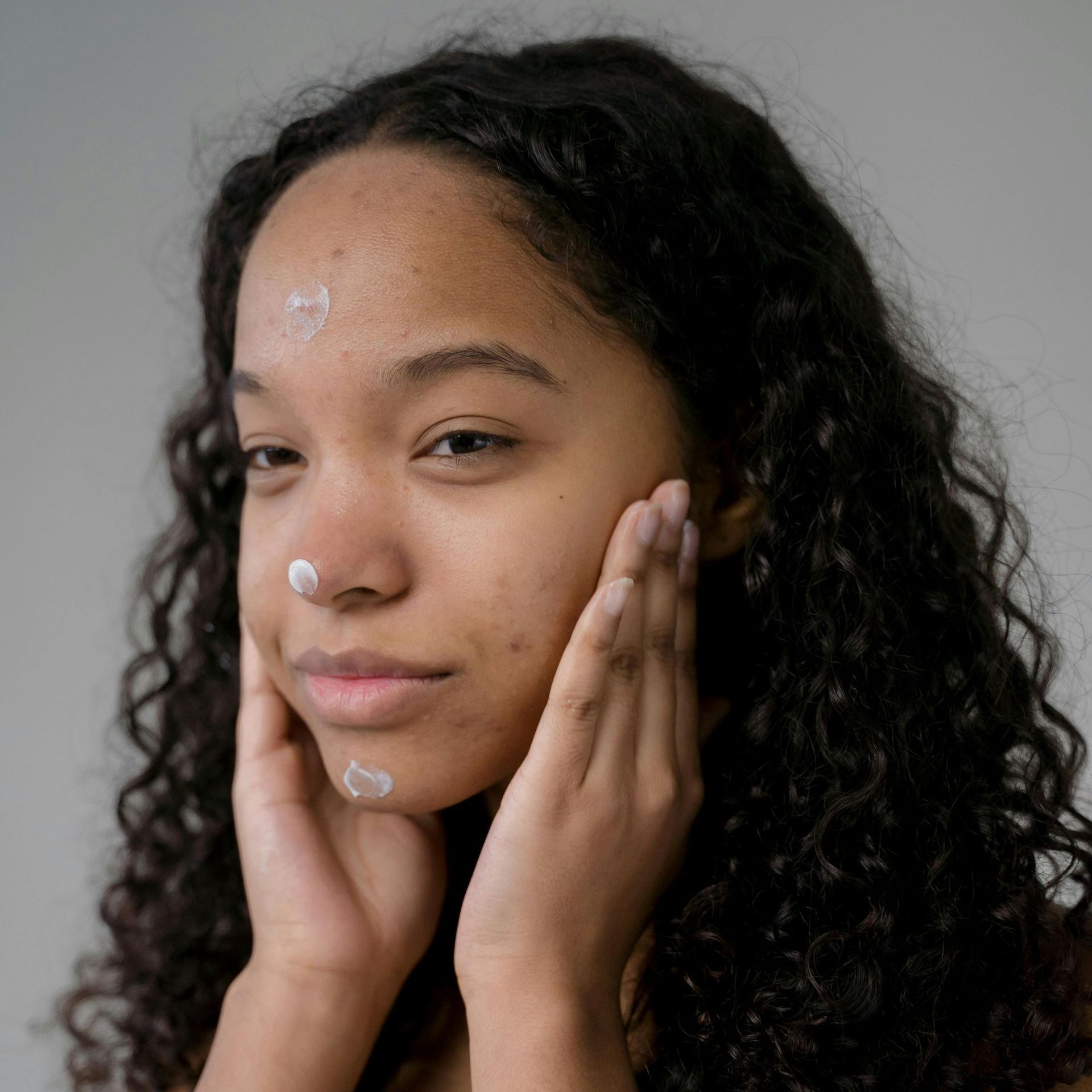 Allow Nourishment / A woman putting tallow face cream on.