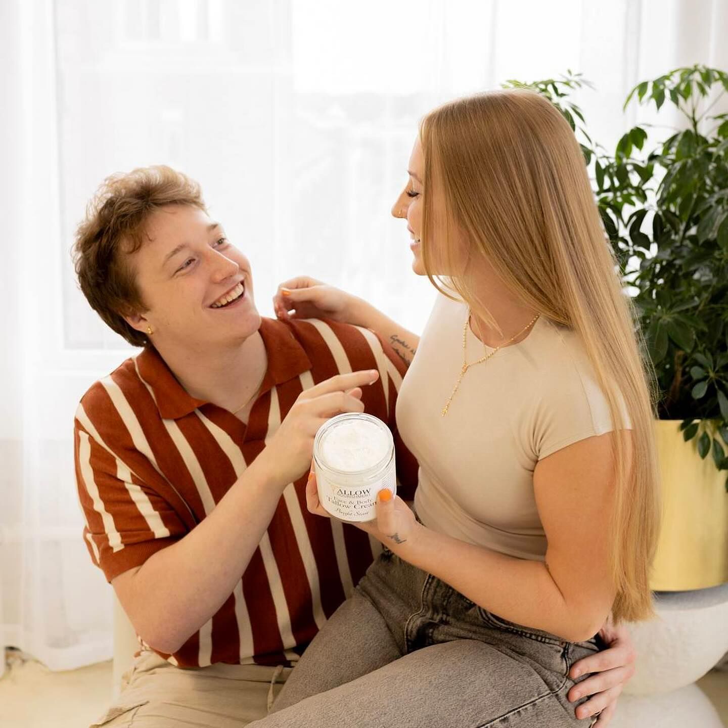 a man and a woman are sitting next to each other on a couch .