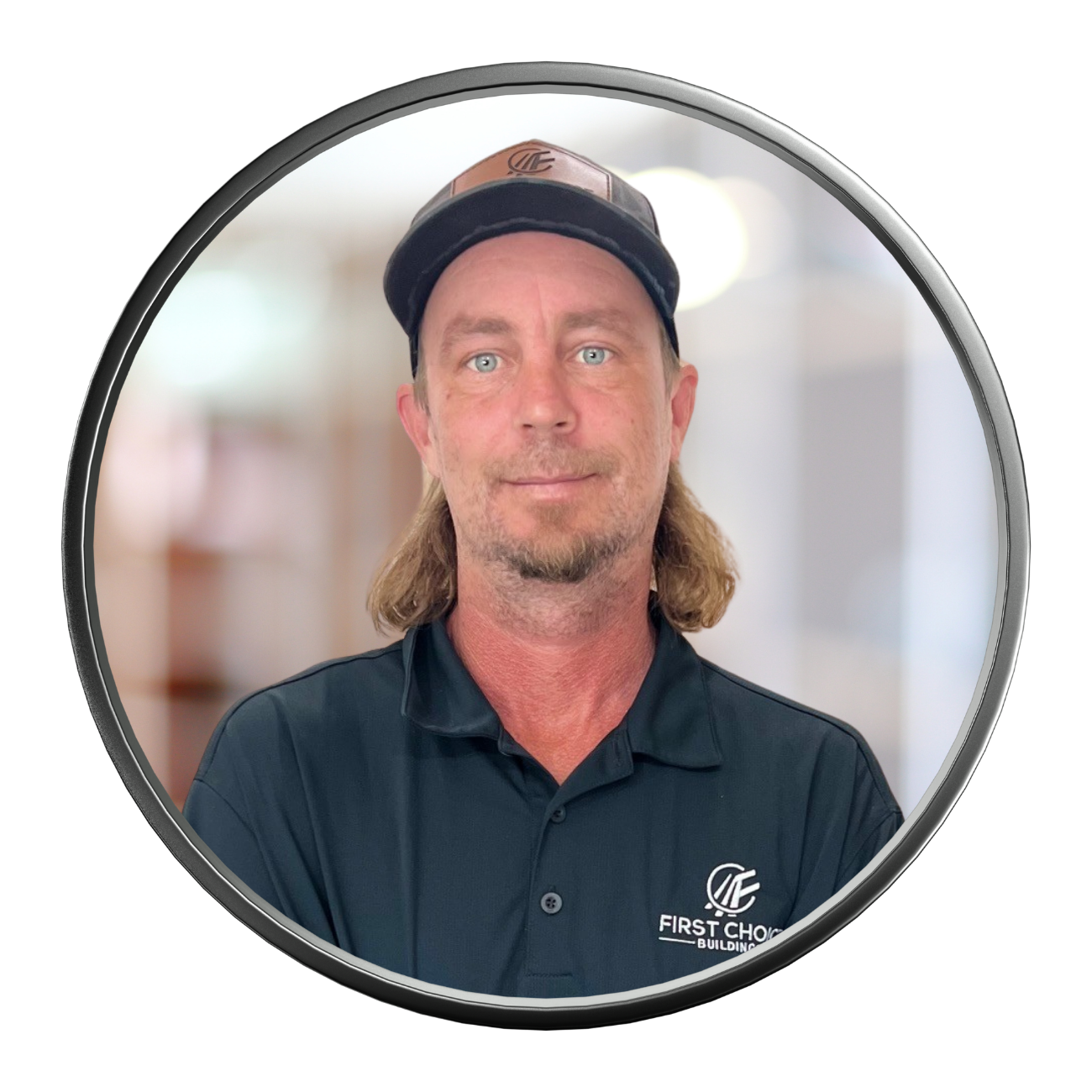 Man with long blonde hair and a hat, wearing a black polo shirt, in a circular frame.