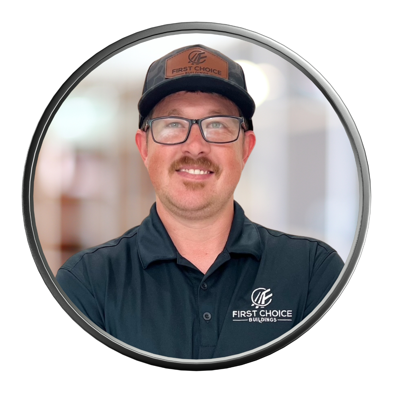 Man in a black polo and hat, wearing glasses, with a mustache, smiling. First Choice logo on shirt and hat.