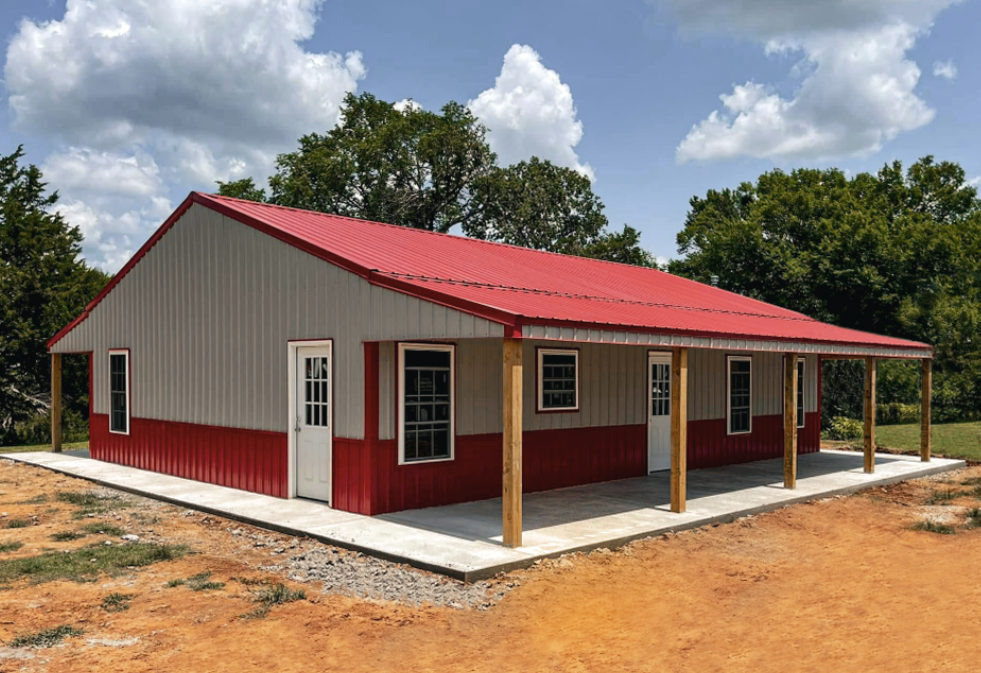 Two-car garage with gray roof, white doors, and gray and brown siding, set on a gravel driveway.
