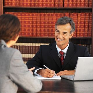 Please show a lawyer talking to a person over a table