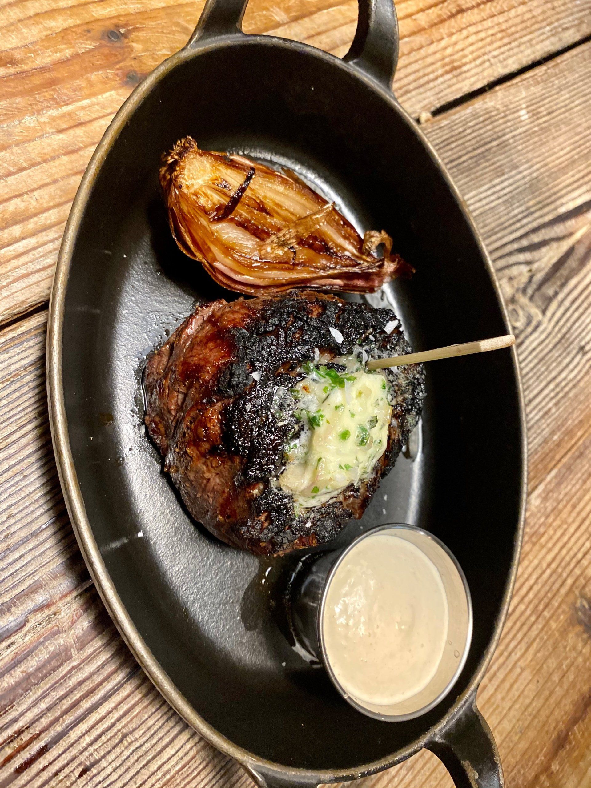 a steak in a pan with a toothpick sticking out of it