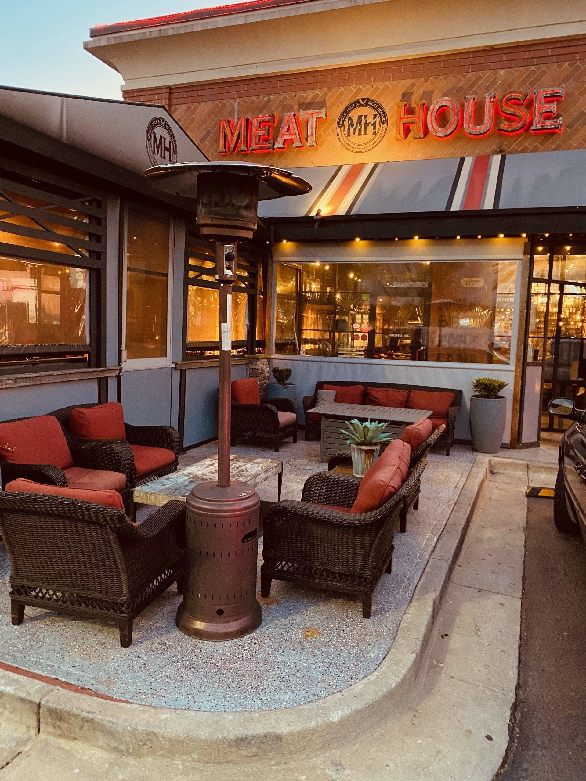 the outside of a restaurant called meat house