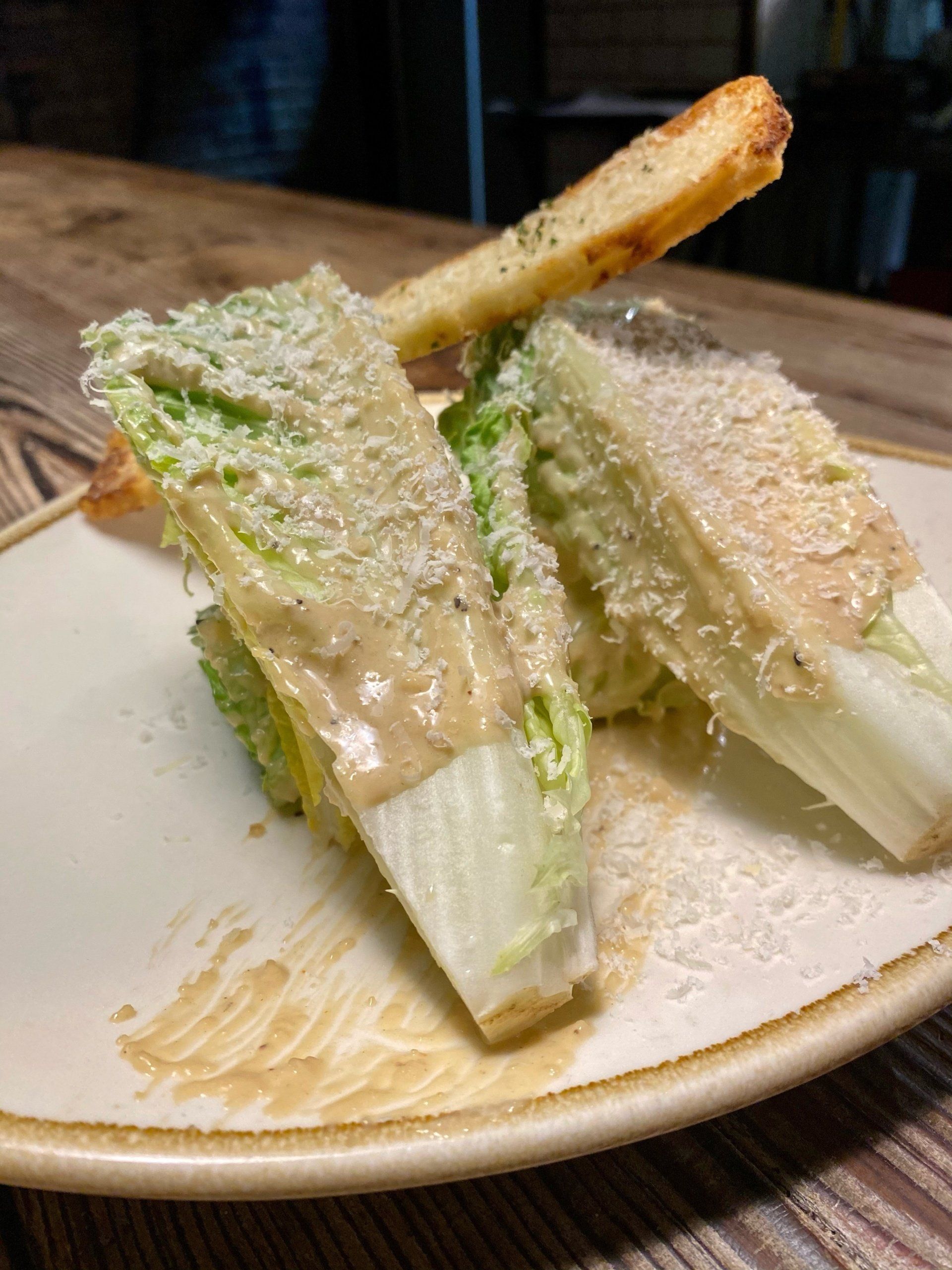 a close up of a caesar salad on a plate