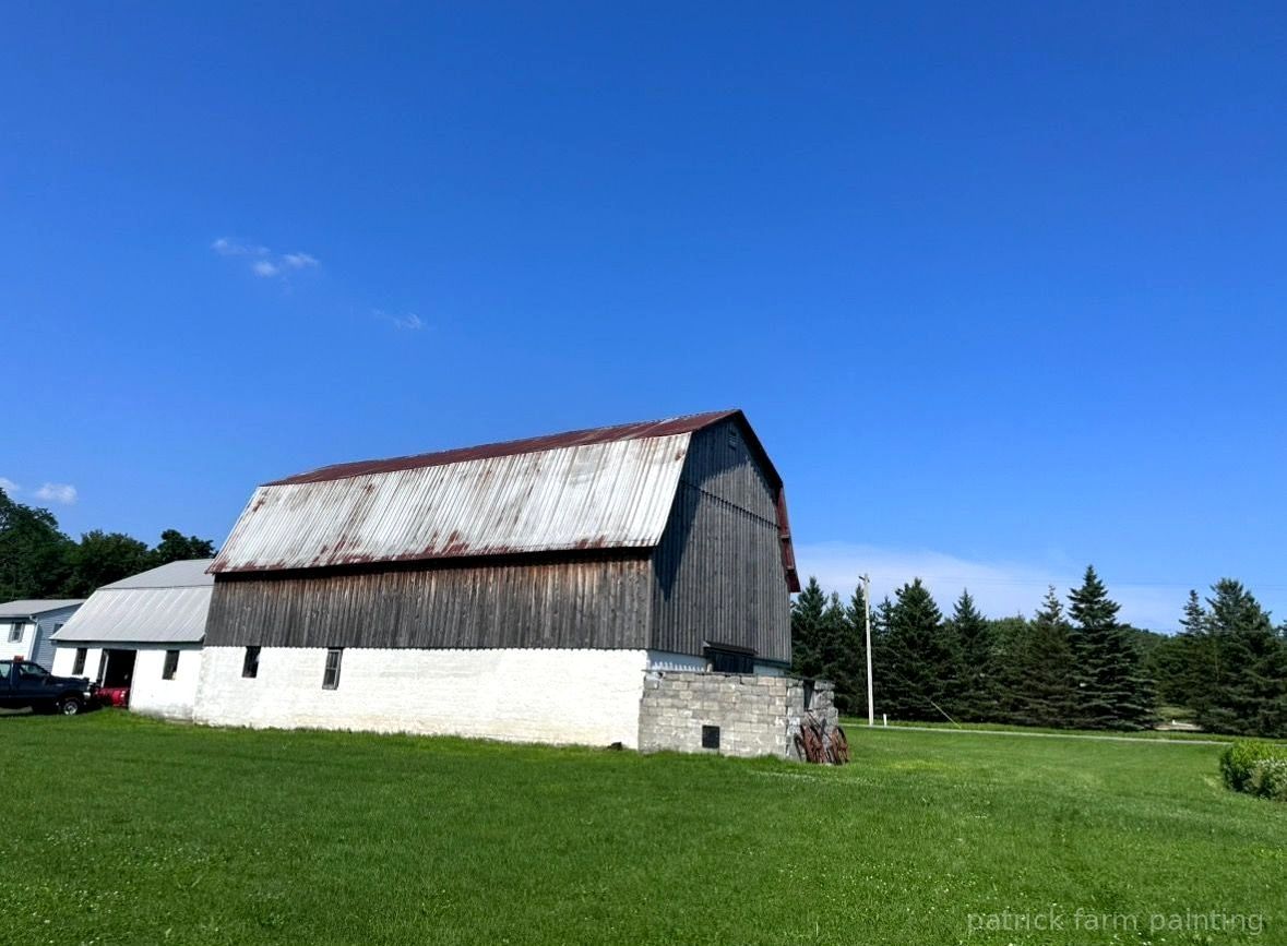 Professional barn painting services by Patrick Farm Painting in Rochester, New York. This image shows a freshly painted rural farm structure with vivid colors, clean lines, and a peaceful countryside setting. The photo highlights the craftsmanship of experienced barn painters and the detailed exterior work completed by the farm painting guy from Patrick Farm Painting, a company that paints barns in New York. The scene includes natural lighting, farm surroundings, and restored siding designed to help visually impaired website visitors imagine the full transformation.