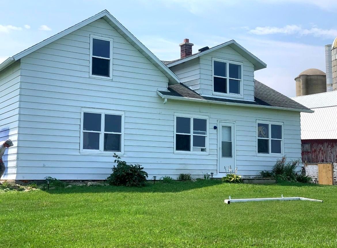 Barn painting services by Patrick Farm Painting in Rome, New York. This image showcases a professionally restored barn or farmhouse surrounded by open farmland, peaceful rural scenery, and natural outdoor lighting. The freshly painted siding, trim, and exterior surfaces highlight the work of experienced barn painters and the trusted farm painting guy from Patrick Farm Painting, a company that paints barns in New York. The agricultural building appears clean, durable, and revitalized with smooth finishes and vibrant color restoration. This detailed description helps visually impaired website visitors imagine the countryside setting, the scale of the structure, and the dramatic transformation completed during the barn painting project.