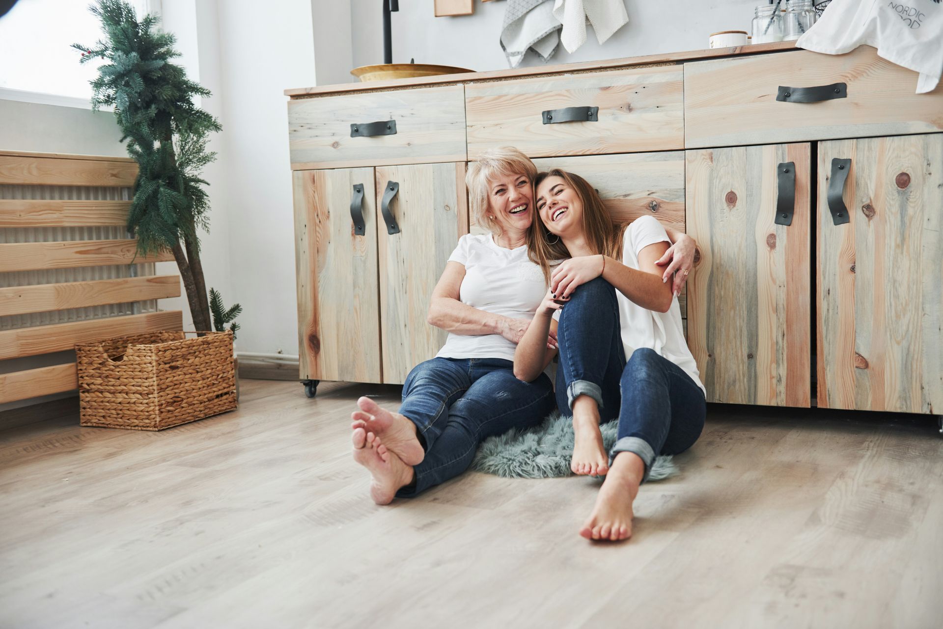 A technician wearing a mask working on a furnace in an attic.