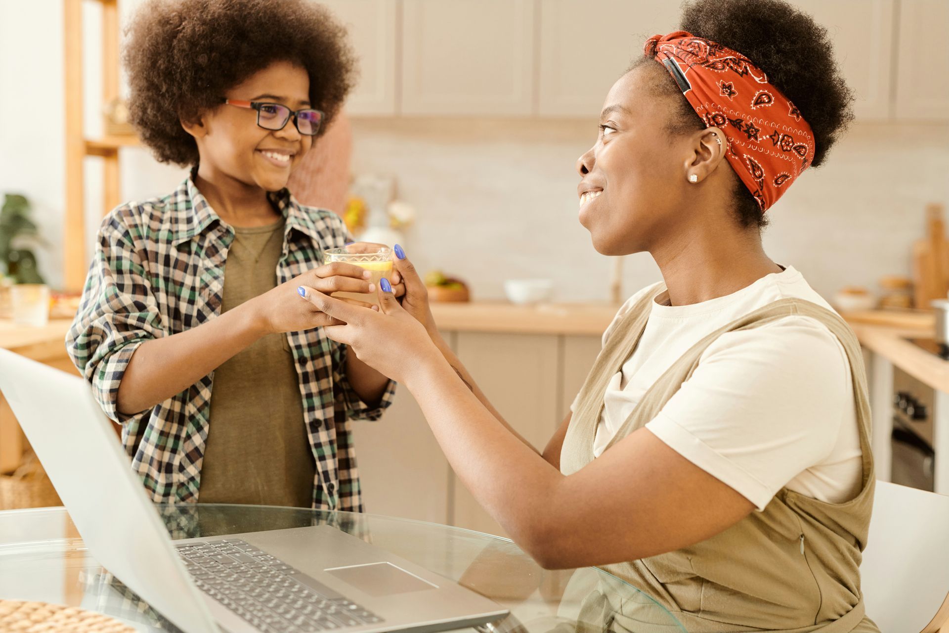 A technician wearing a mask working on a furnace in an attic.