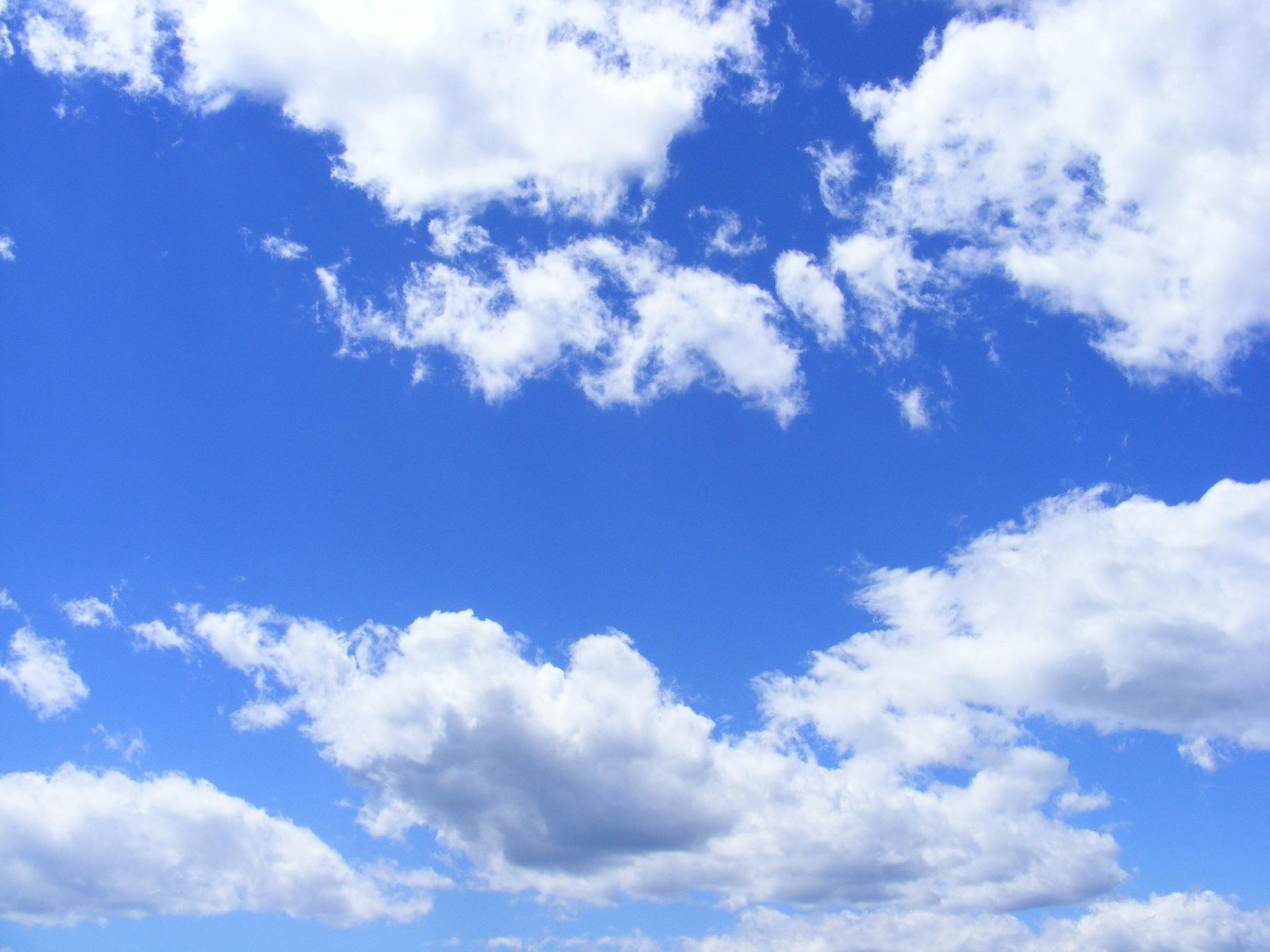 Blue sky with white puffy clouds.