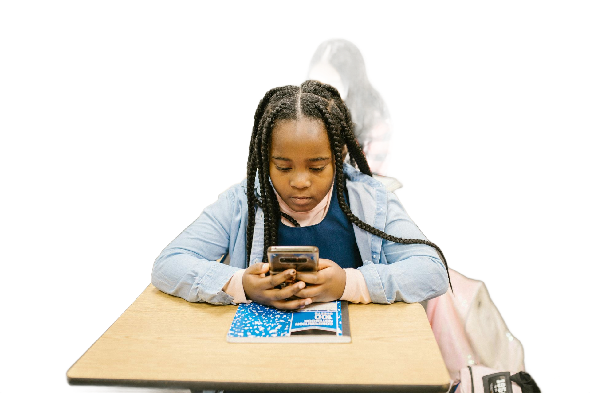 Girl with braids focused on phone at desk; classroom setting with another student behind.