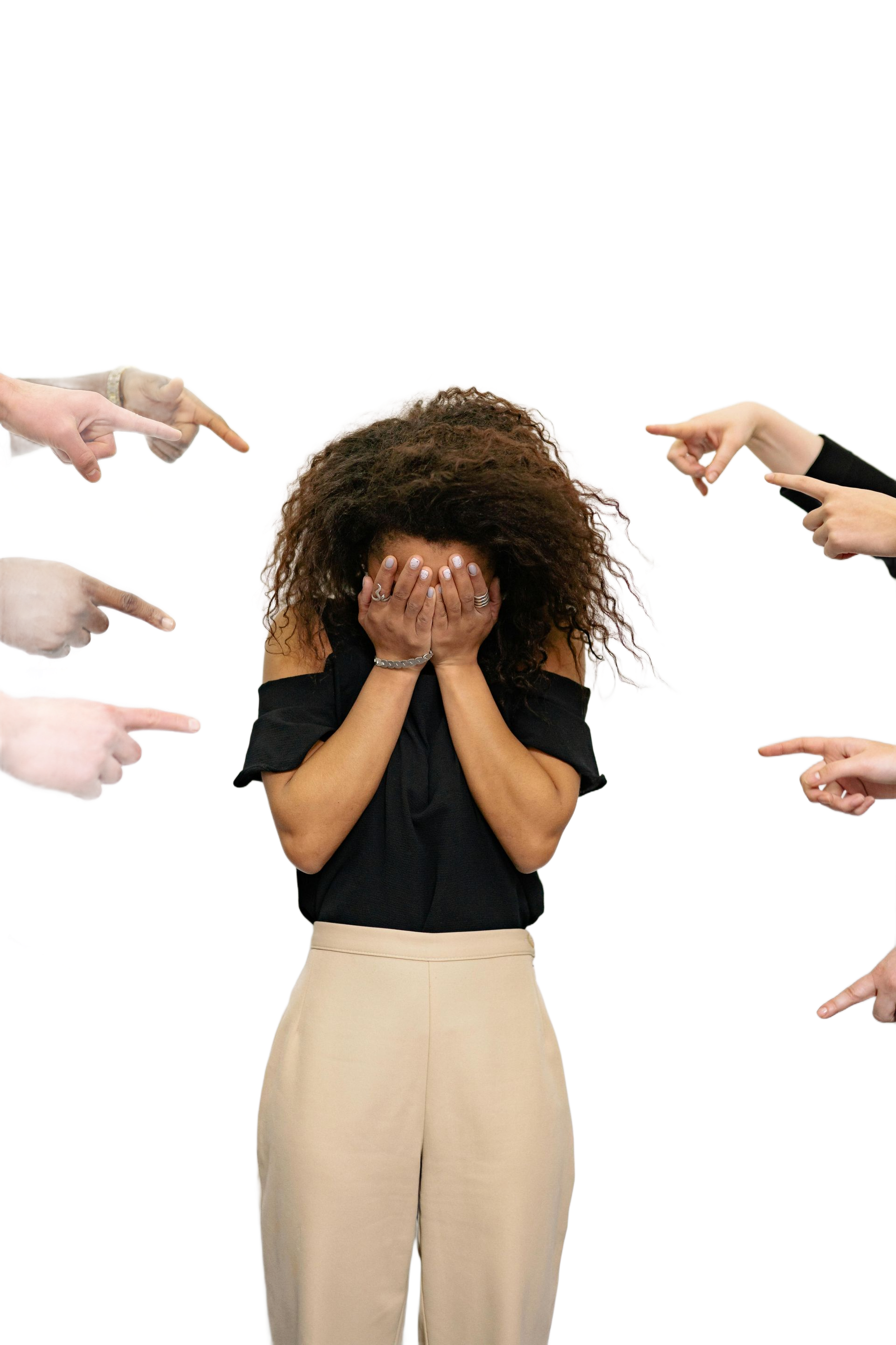 Woman with curly hair covering face, surrounded by pointing fingers.