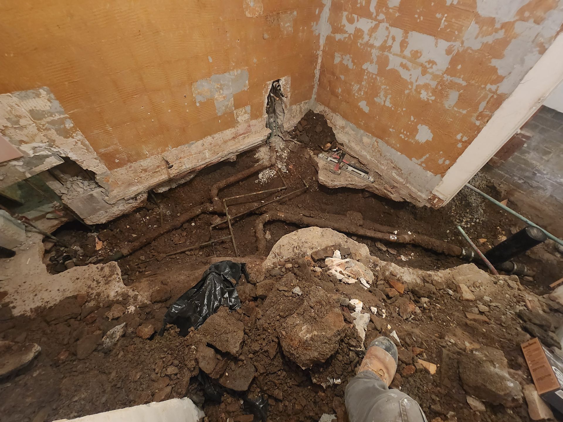 A person is digging in the dirt in a room