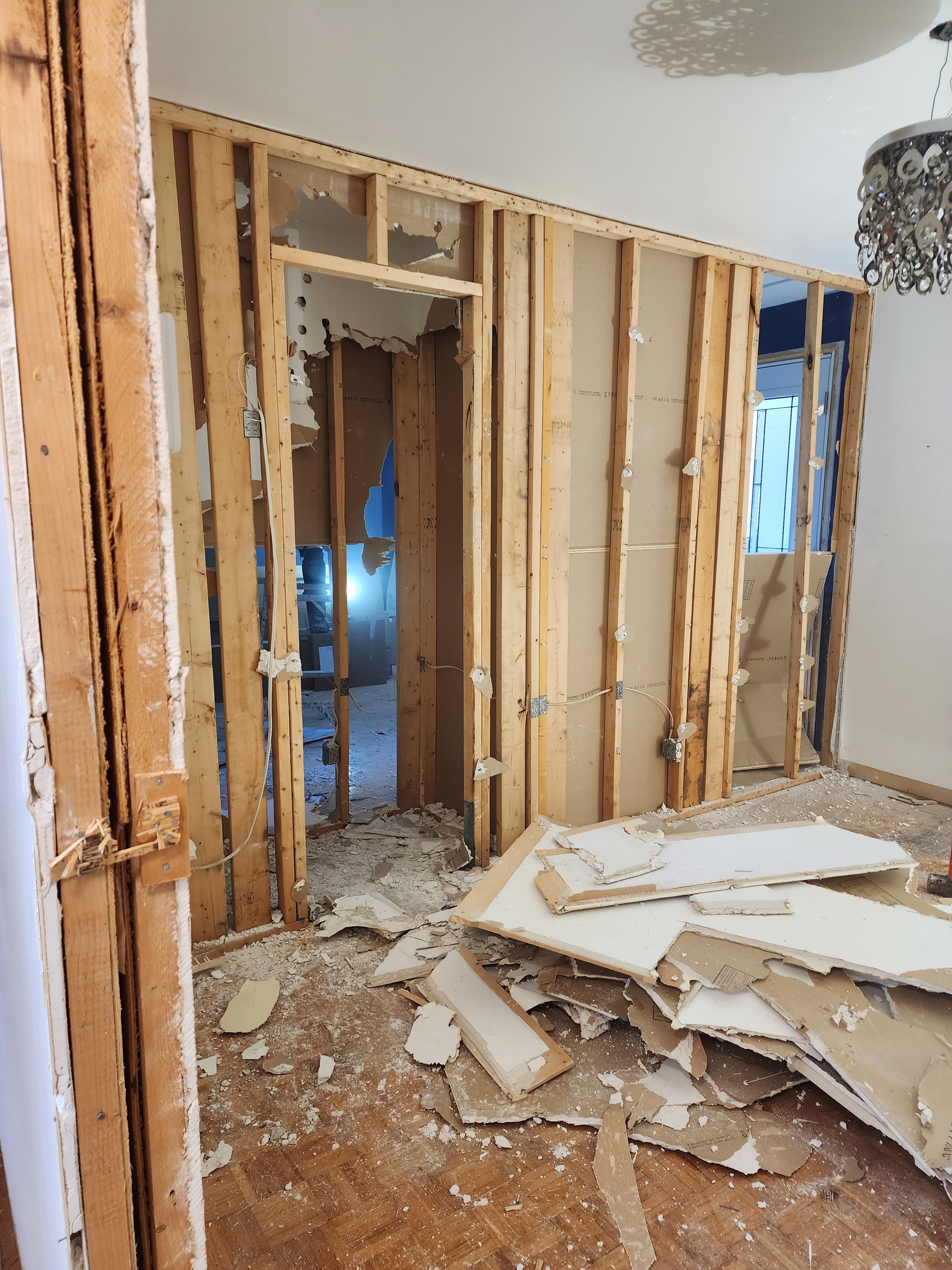 A room with a lot of pieces of wood on the floor.