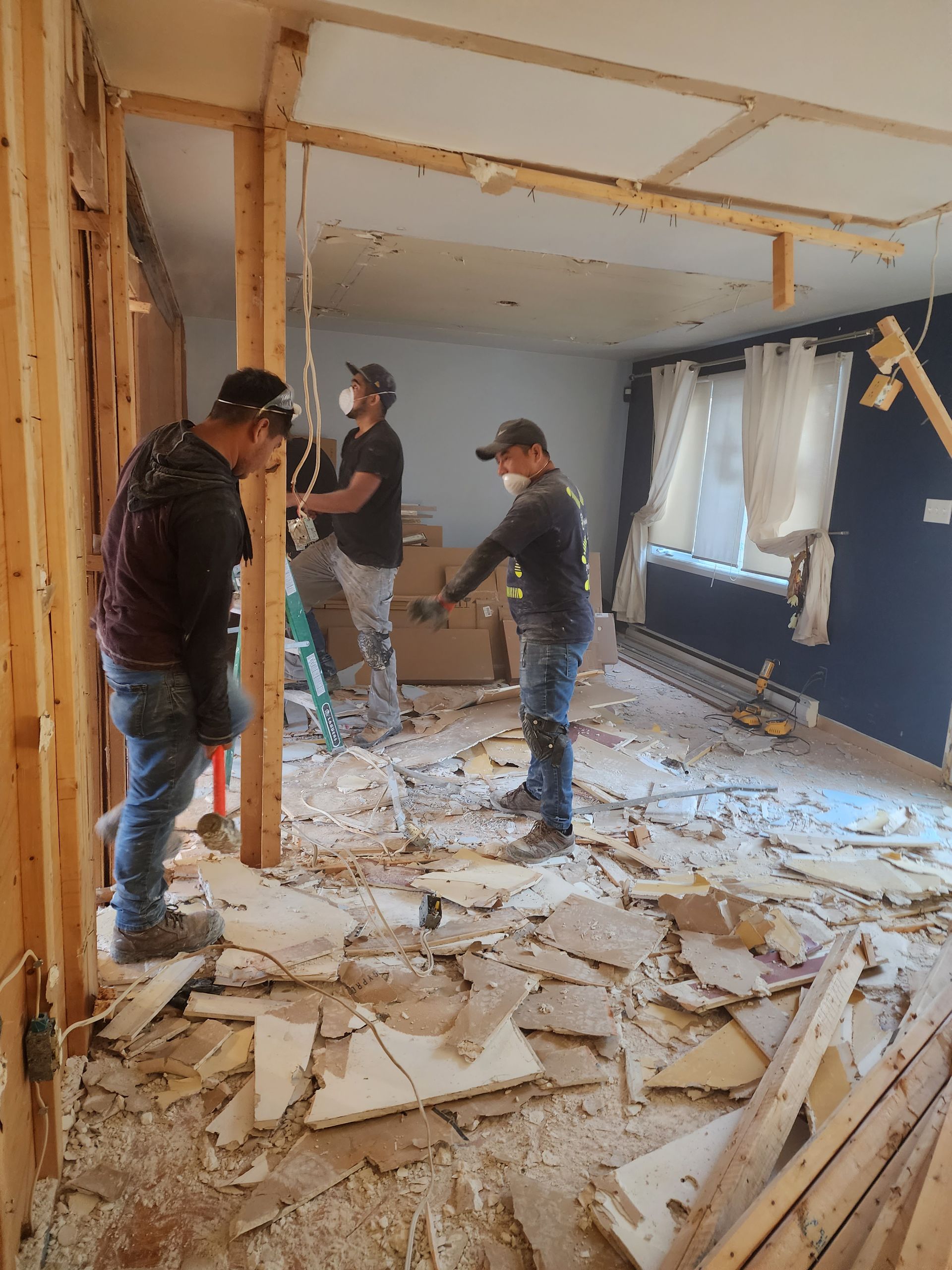 A group of men are working in a living room.